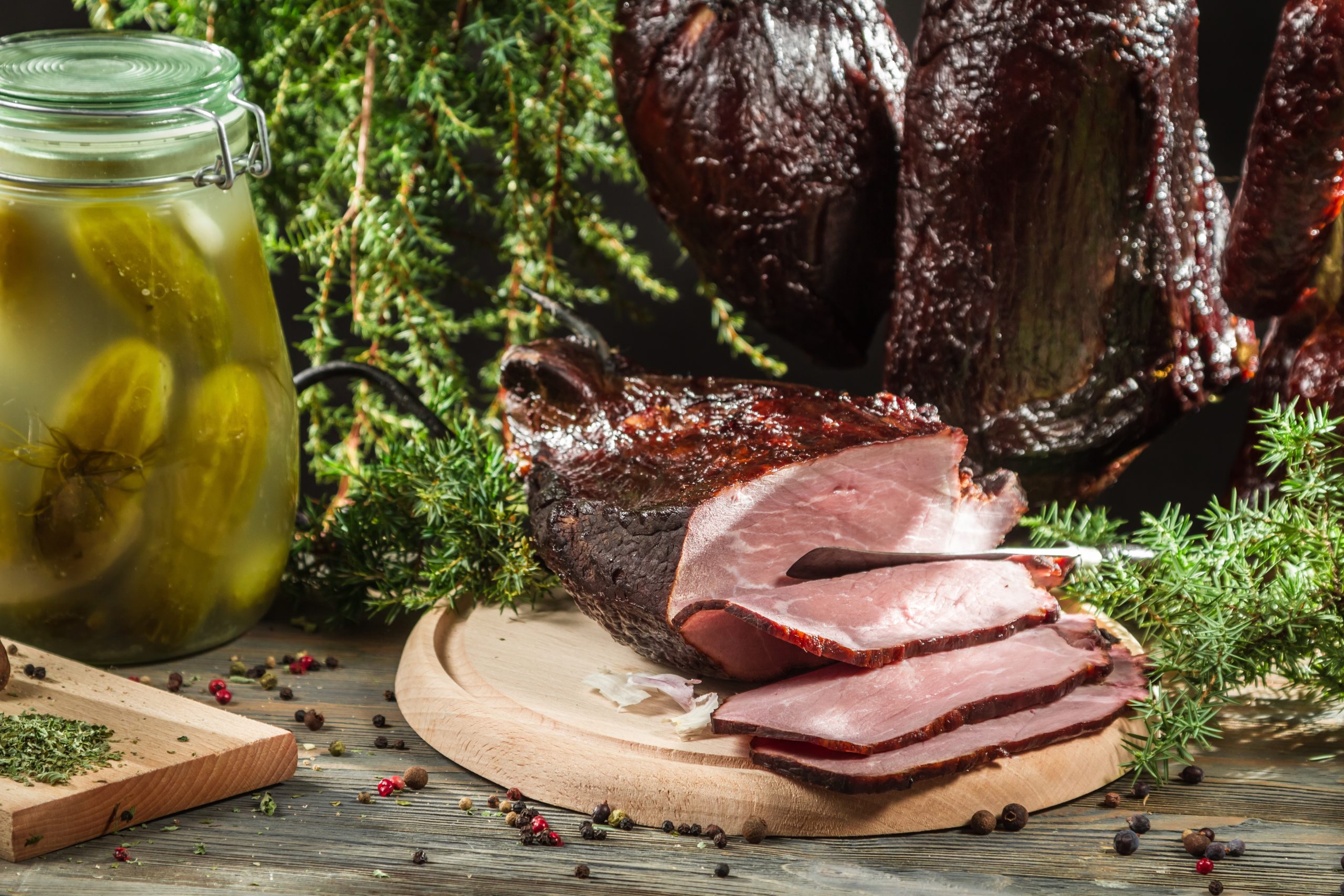 freshly smoked ham on a table with other spices 