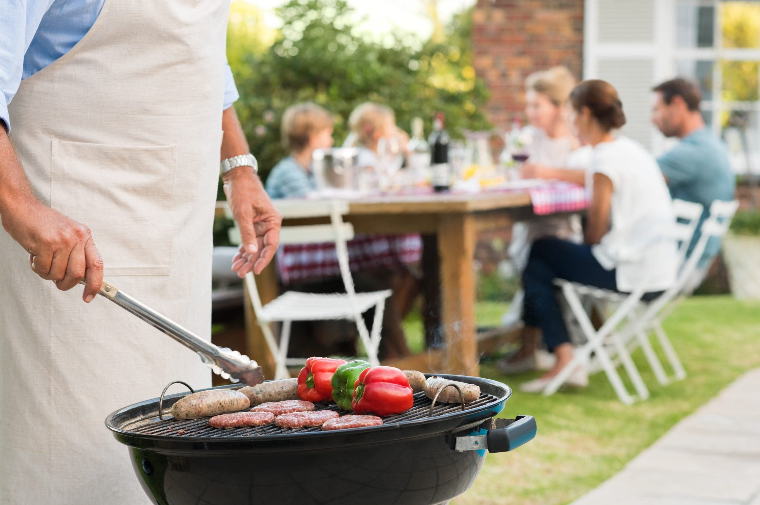 family get together celebrating National BBQ Month in the backyard 